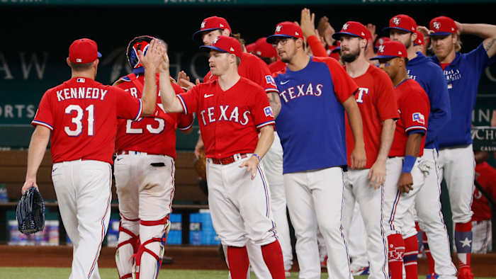 Jun 4, 2021; Arlington, Texas, USA; Texas Rangers relief pitcher Ian Kennedy (31) high fives teams after picking up the save against the Tampa Bay Rays at Globe Life Field.